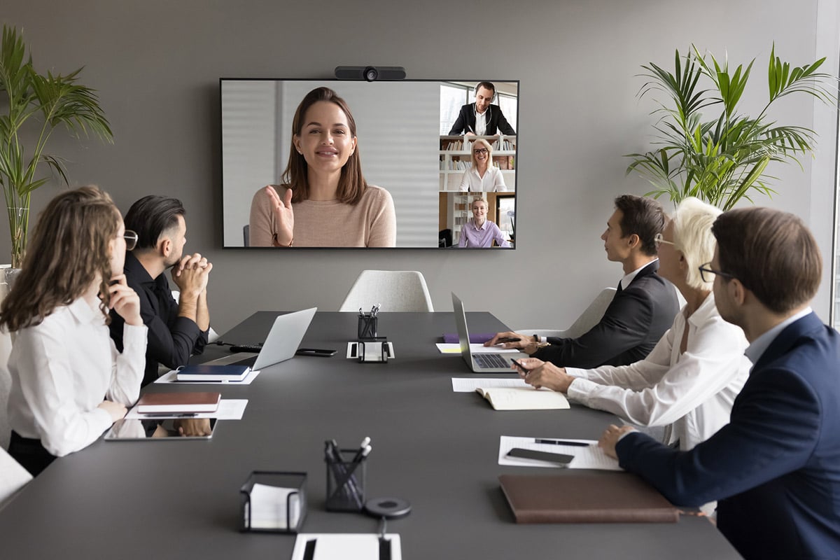 Business executives engaged in a remote cybersecurity strategy meeting with virtual CISOs.